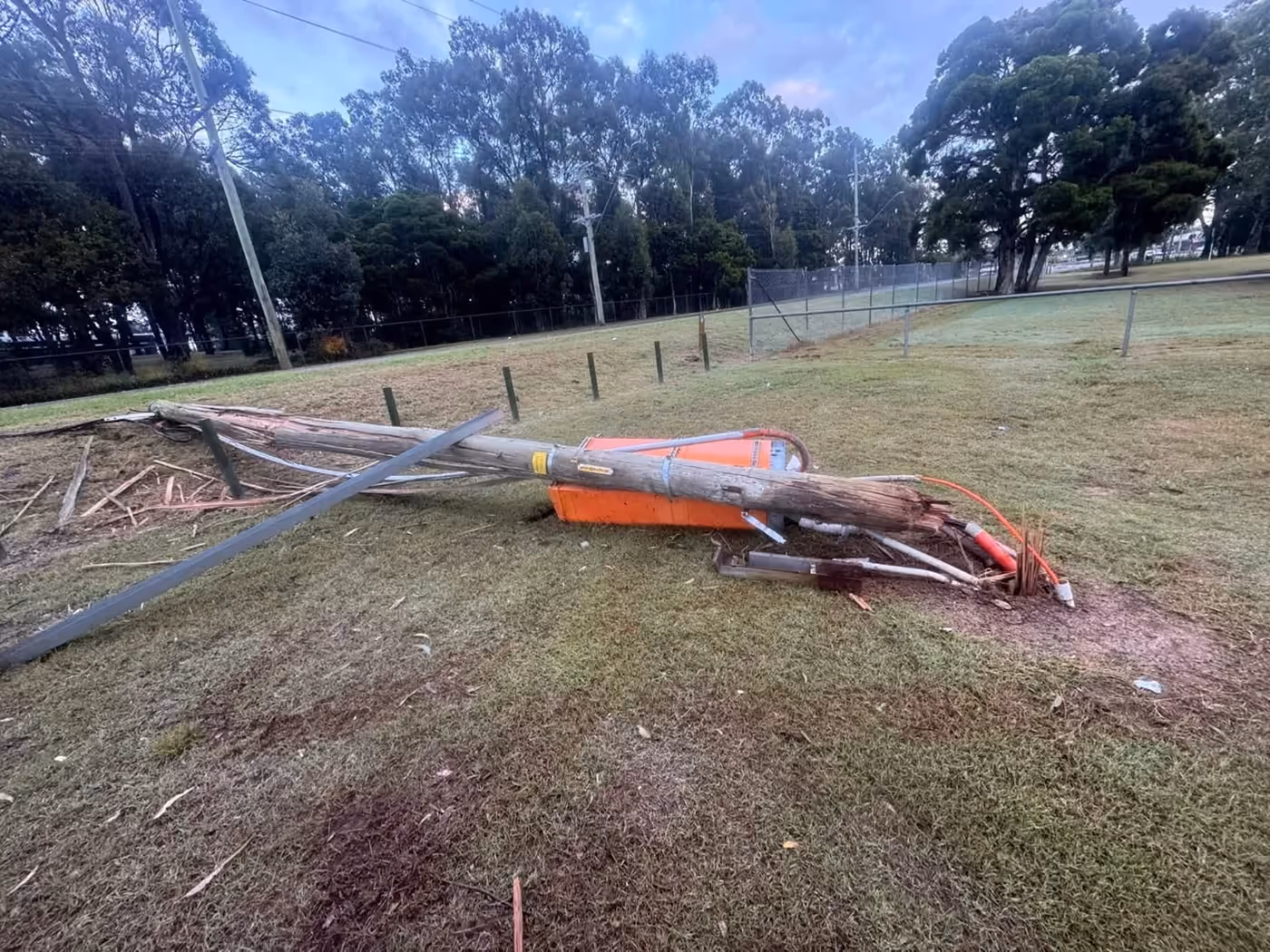 Fallen private power pole and damaged electrical enclosure