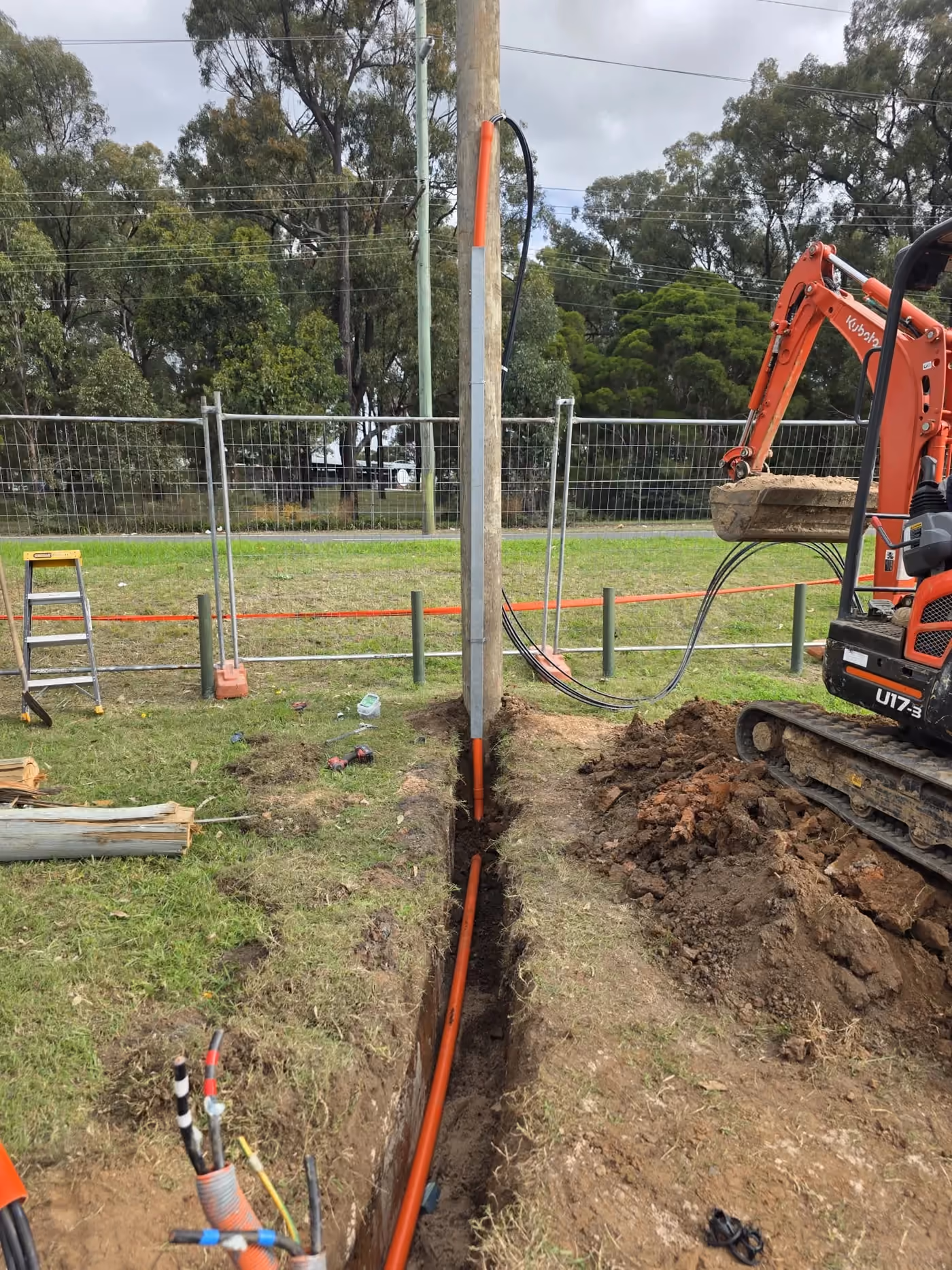Private power pole with underground electrical conduit during installation